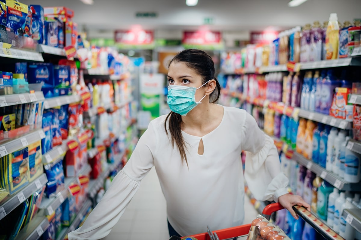 Woman with mask shops in a supermarket